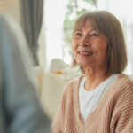 An elderly asian woman smiling